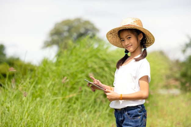 Outdoor Portrait Of A Little Girl Farmer On Rice Fields