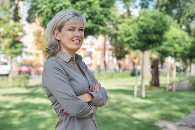 Outdoor portrait of mature businesswoman on city street