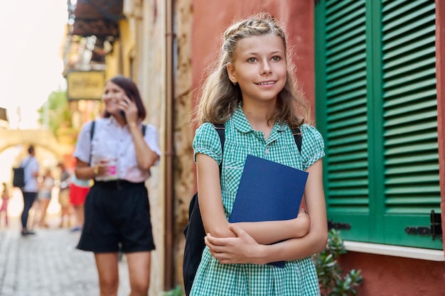 Outdoor portrait of a preteen female student on a city street