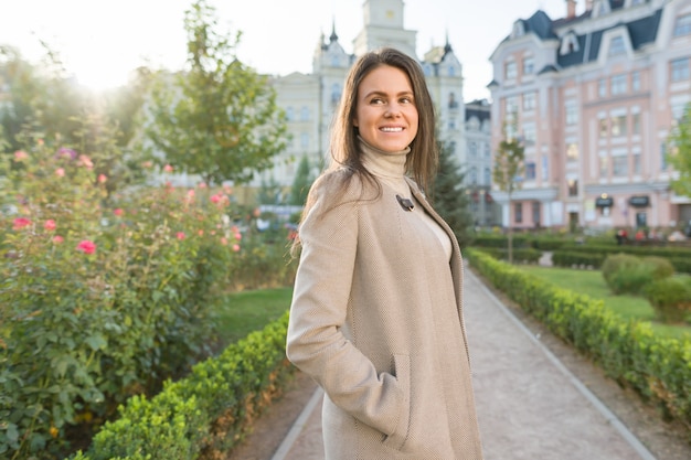 Outdoor portrait of a smiling happy young woman