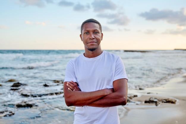 Outdoor portrait of smiling young African American man looking in camera