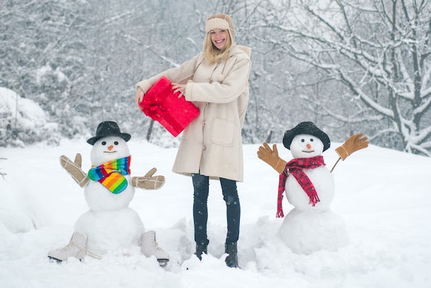 Outdoor portrait of winter girl with gift in cold sunny winter weather in park love winter