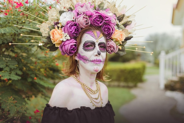 Outdoor portrait of woman made up as catrina. Mexican woman made up as catrina for day of the dead