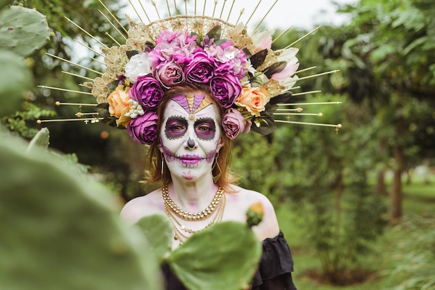 Outdoor portrait of woman made up as catrina. Mexican woman made up as catrina for day of the dead