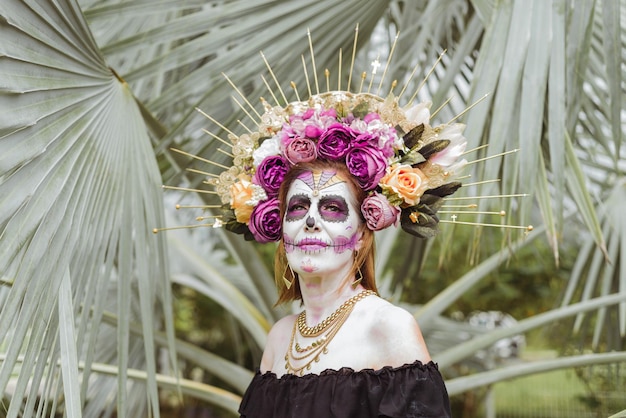 Outdoor portrait of woman made up as catrina. Mexican woman made up as catrina for day of the dead