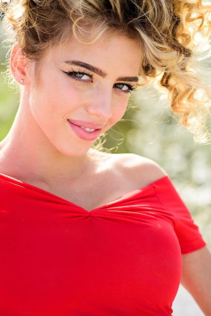 Outdoor portrait of young beautiful happy smiling girl wearing red dress Spring summer fashion