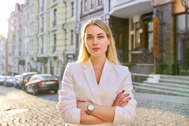 Outdoor portrait of young beautiful woman on city street