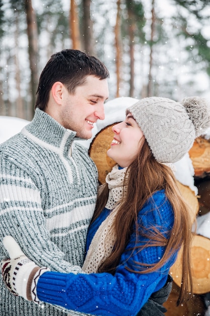 Outdoor portrait of young sensual couple in cold winter wather. love and kiss