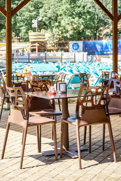 Outdoor street cafe with designer plastic furniture in aqua park on sunny summer day