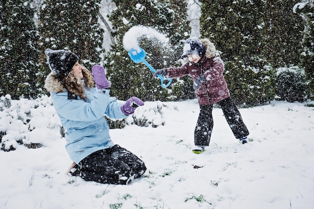 Outdoor winter activities for kids and family let it snow happy family mom and kid boy having fun