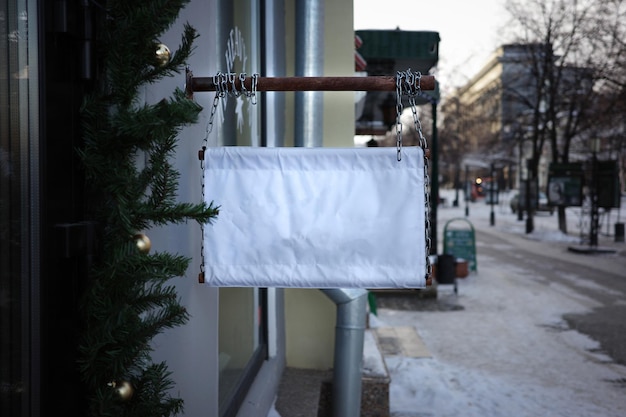 Outdoor winter shop sign design branding mockup. Signboard hanging on a chains