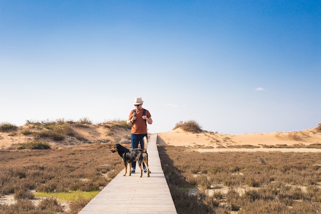 Outdoors lifestyle image of travelling man with cute dog. 