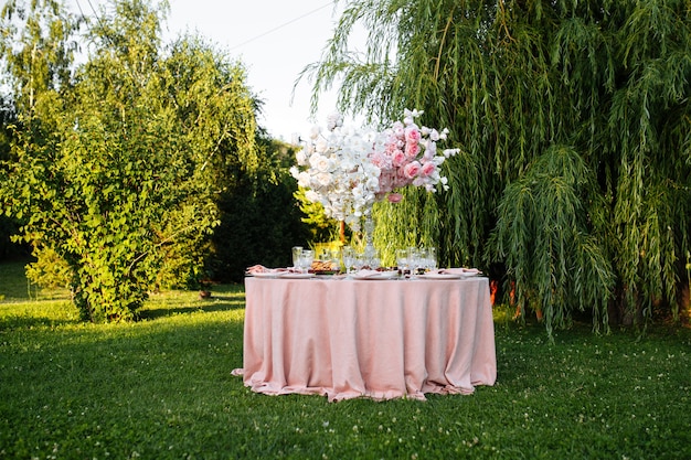 Outdoors nature banquet table set with candles