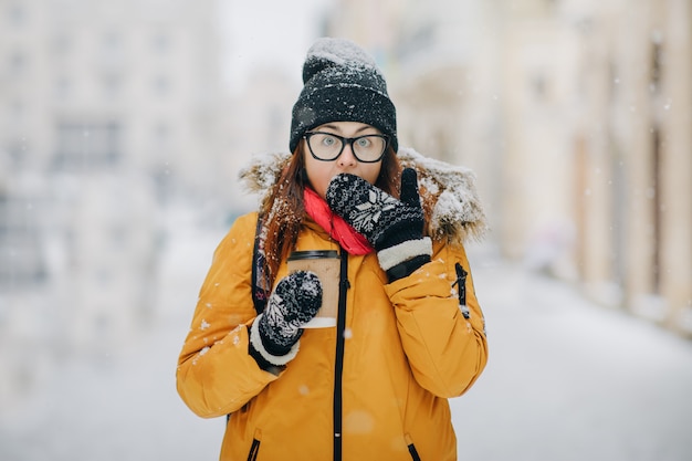 Outdoors portrait of beautiful young girl Having Good News. Excited beautiful woman in early 30s winning something shouting for joy and celebrating