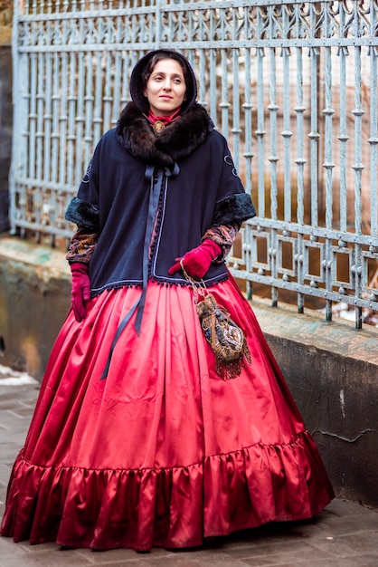 Outdoors portrait of a young victorian woman walking old city