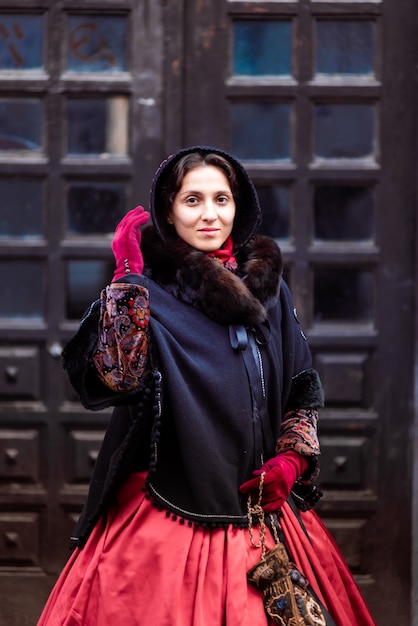 Outdoors portrait of a young victorian woman walking old city