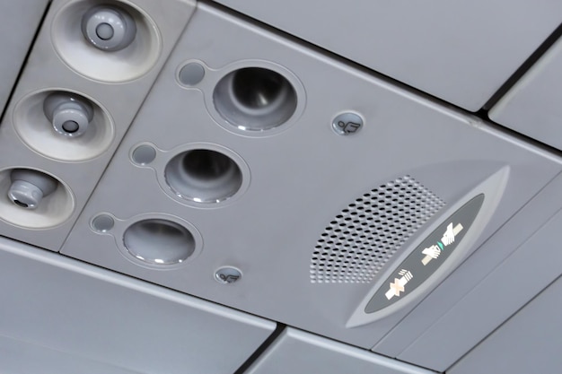 Overhead console panel showing air conditioner, lighting switch and flight attendant call buttons