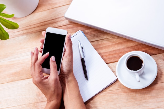 Overhead of feminine hands using smartphone