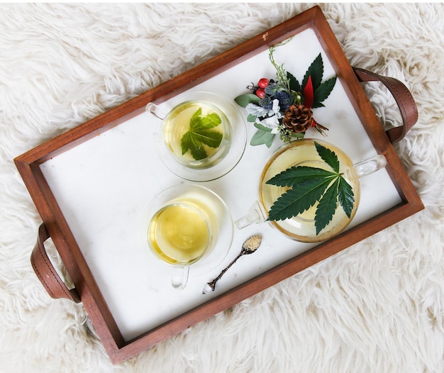 Overhead shot of a healthy CBD Infused Chamomile Based Tea on a wooden flat tray