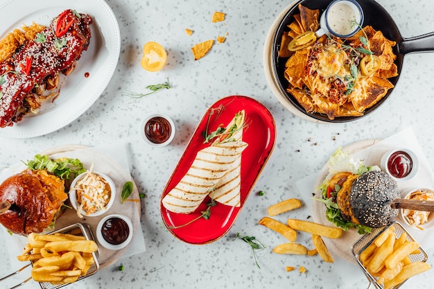 Overhead shot of a variety of fast foods and sauces on the table