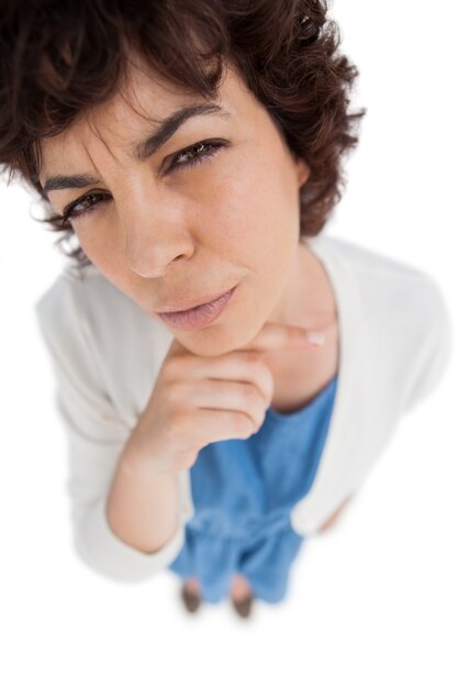 Overhead of standing woman touching her chin