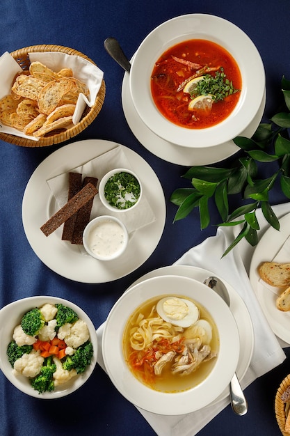 Overhead view of assortment food in restaurant on blue tablecloth