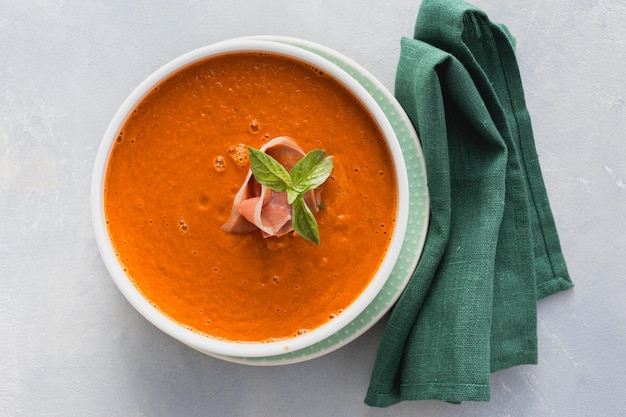 Overhead view bowl cream baked tomato soup with ham