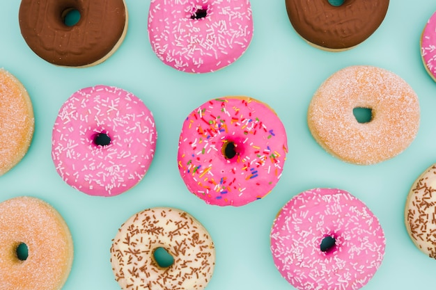 An overhead view of donuts on blue background