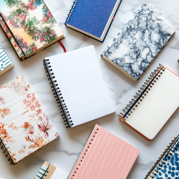 Photo overhead view of multiple open notebooks on white desk editorial photography