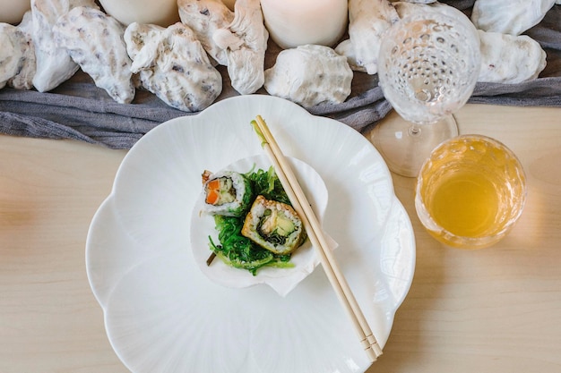 Overhead view of plates of sushi and a table setting for a celebration meal