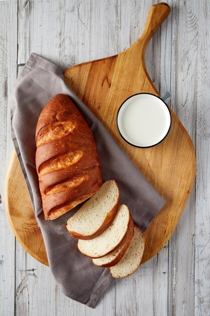 Overhead view of sliced homemade bread on wooden board