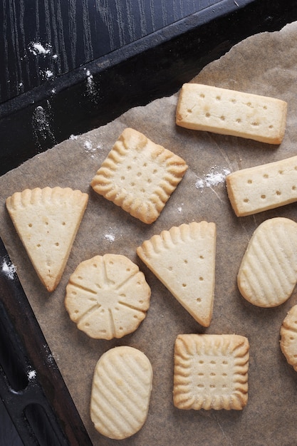 Overhead view of various shortbread cookies on a baking sheet