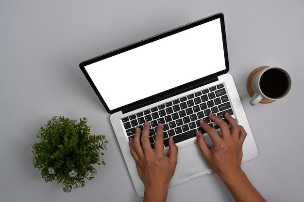 Overhead view woman hands typing on laptop computer Blank screen for your advertise text