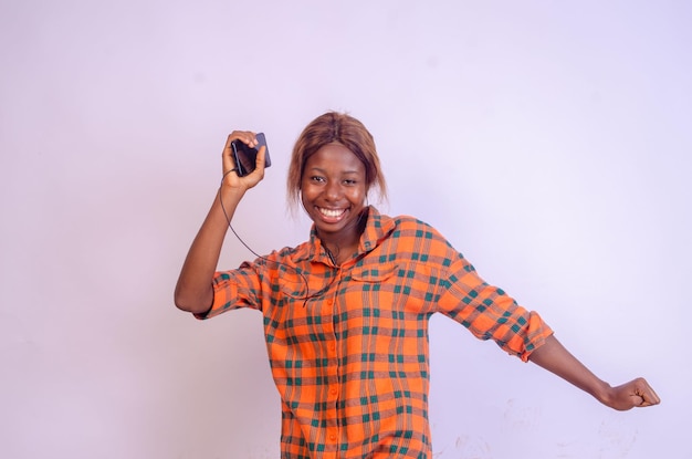 Overjoyed young black woman using her phone looking amazed