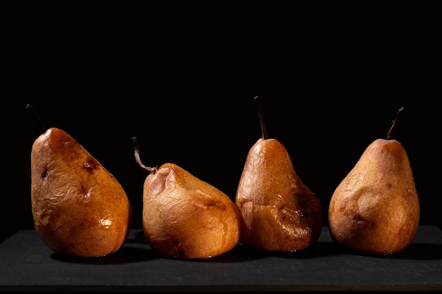 Overripe pears with black background and warm lighting