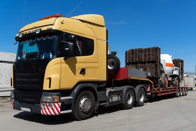 Oversized heavy transportations by truck. High industrial cargo shipped on the trawl.