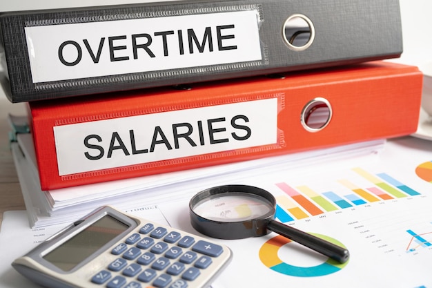 Overtime salaries Binder data finance report business with graph analysis in office