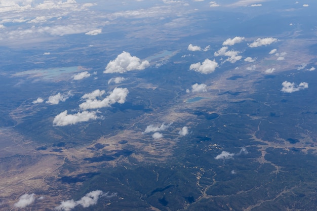 Overview of fluffy clouds in mountains from an airplane, Arizona USA