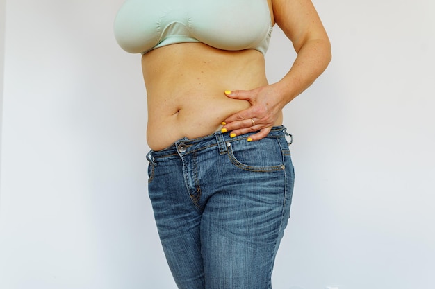 Overweight woman showing fat belly