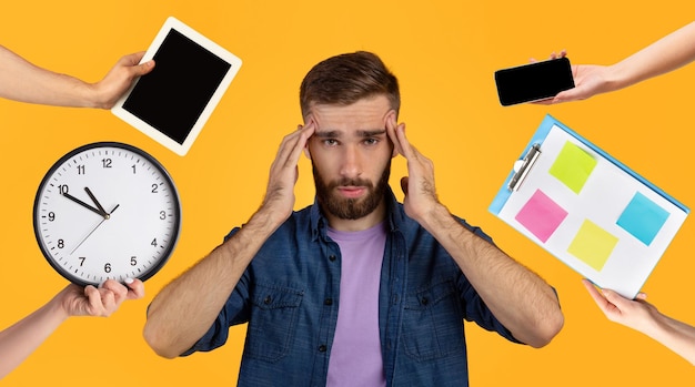 Photo overwhelmed young man having difficulties with time management