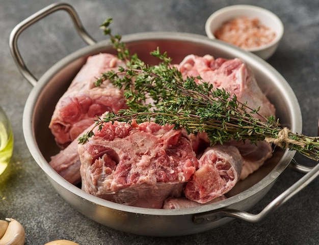 Oxtail Bones Being in Stainless Steel Skillet