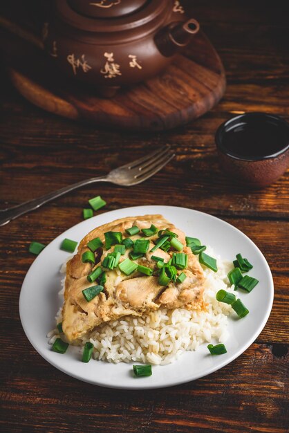 Oyakodon dish on white plate in rustic setting