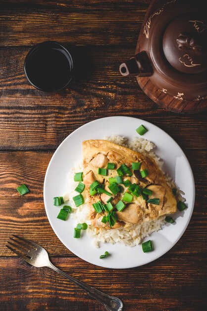 Oyakodon. Japanese rice dish with chicken, egg, sliced scallion