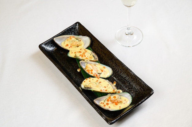 Oysters with red caviar on white background.Opened oysters with red caviar.Top view, flat lay, copy space.