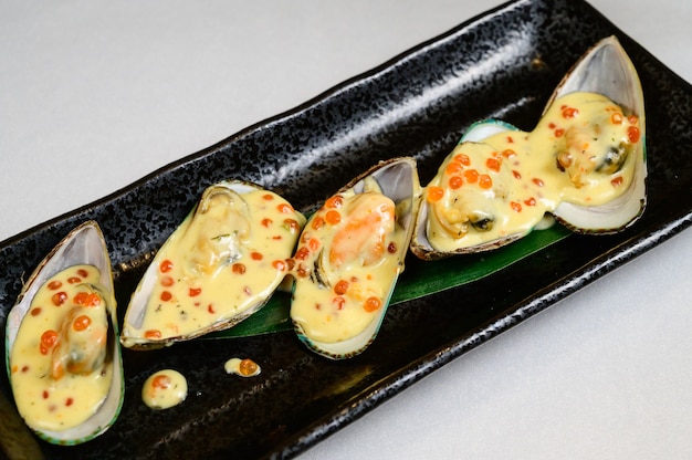 Oysters with red caviar on white background.Opened oysters with red caviar.Top view, flat lay, copy space.