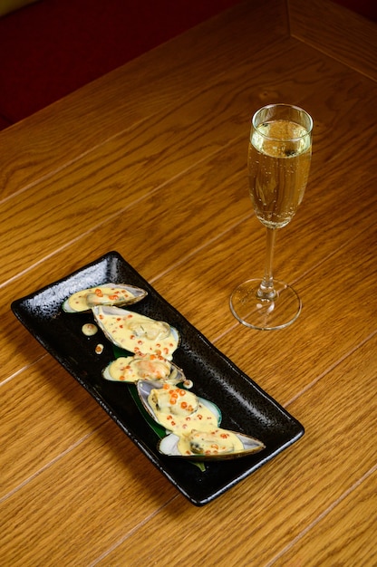 Oysters with red caviar on wooden background.Opened oysters with red caviar.Top view, flat lay, copy space.