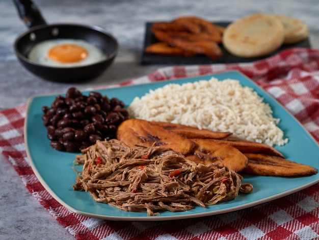 Pabellon criollo with eggs typical Venezuelan and Colombian food with shredded meat rice and beans