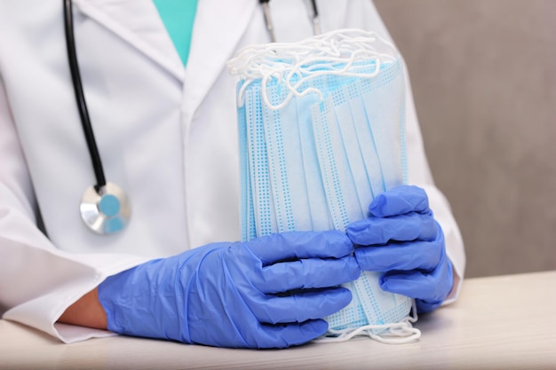 Pack of medical disposable face masks in the doctors hands