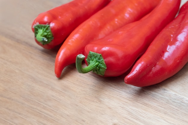 Pack of red peppers on wooden table