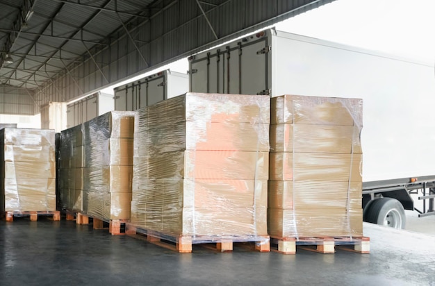 Packaging Boxes Stacked on Pallets Loading into Shipping Cargo Container Trucks Freight Logistics